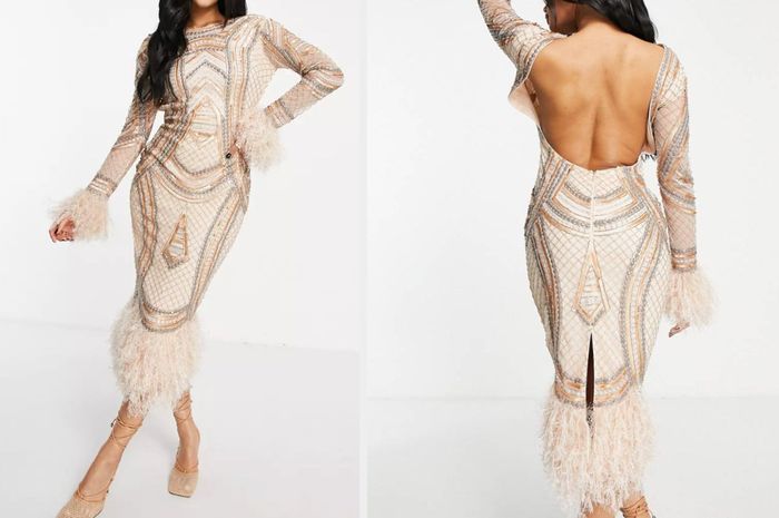 The model is wearing a stunning brown and silver midi dress embellished with beads and sequins, featuring a feather trim and a backless design with a slit in the back.