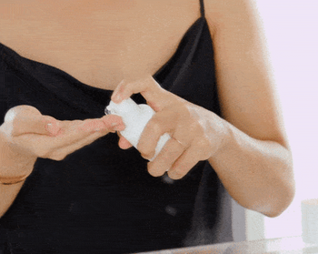 A gif of a model applying the serum to their hands and gently massaging it into their face