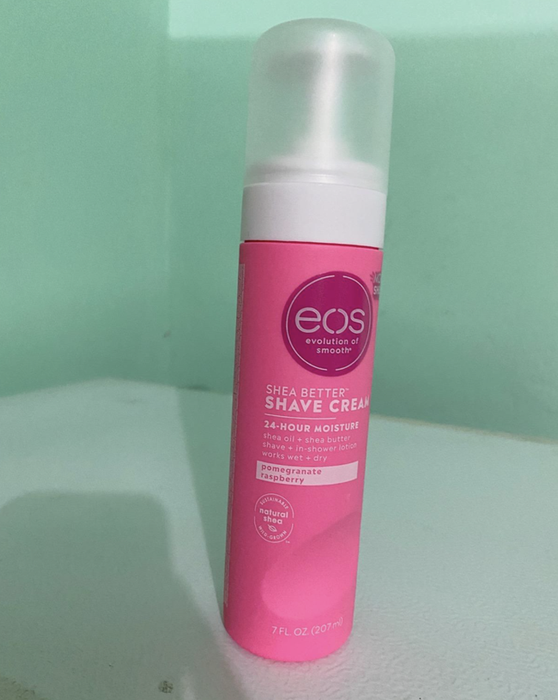 Reviewer showcasing the pink canister of the shaving cream