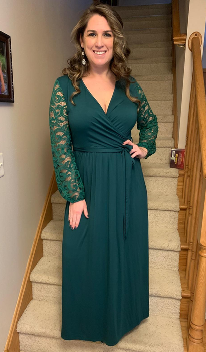 Image of a reviewer wearing a green dress.
