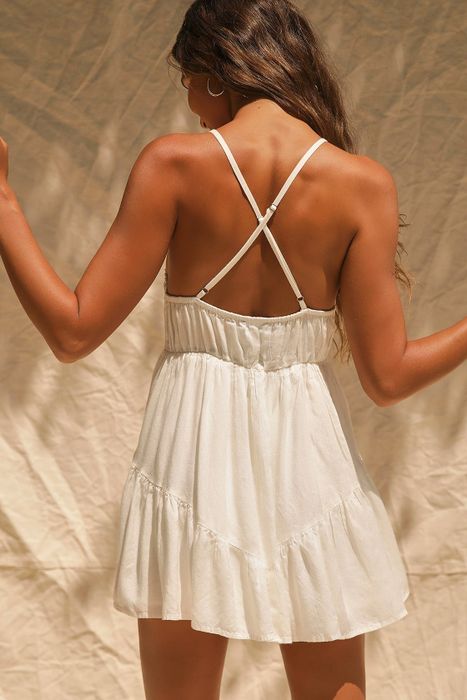 Model showcasing the back of the dress with stylish crisscross straps.