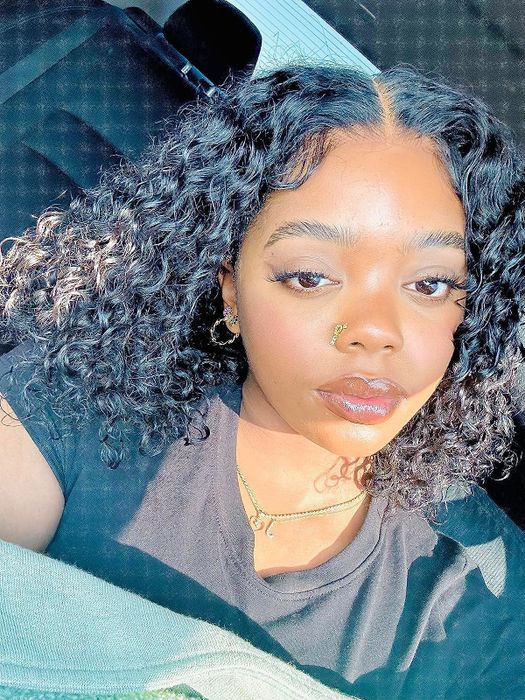 A reviewer showing off their glowing skin after using the serum.