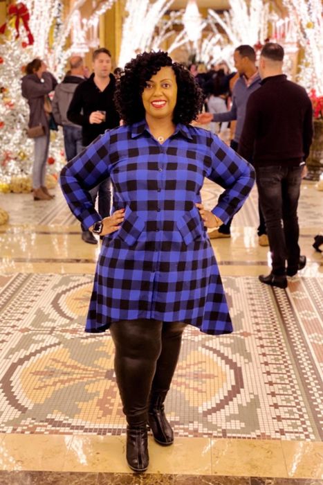 A customer review image of them in the blue and black buffalo plaid long-sleeve dress