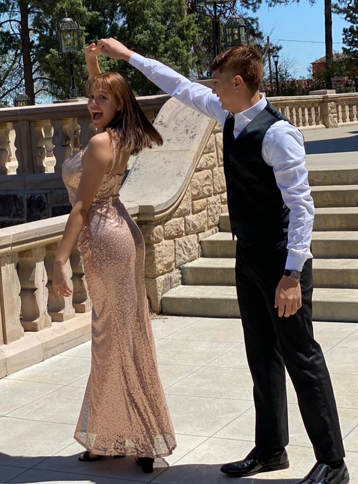 A reviewer twirling in the dress outdoors