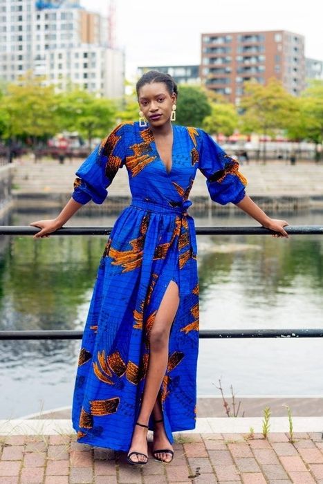Model wearing the stunning blue maxi dress with an intricate African print design.