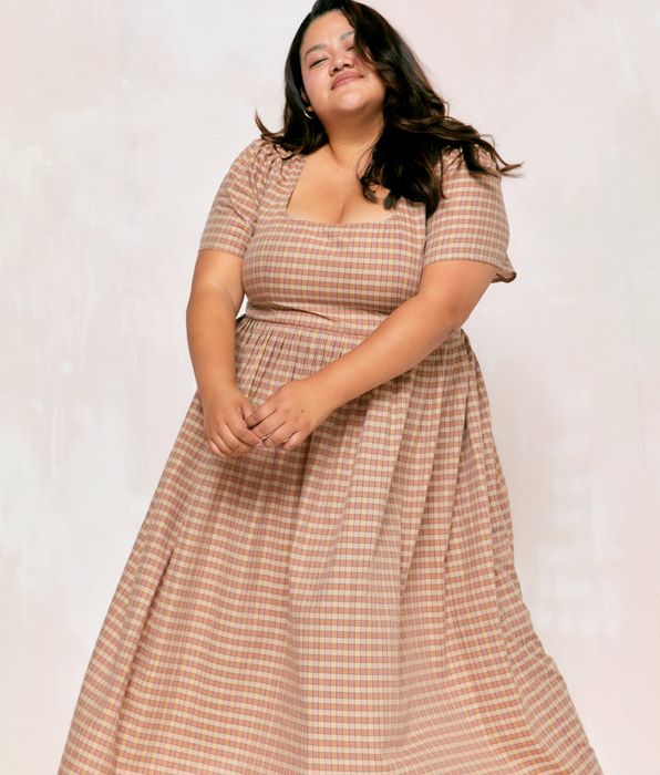 model wearing the brown plaid dress