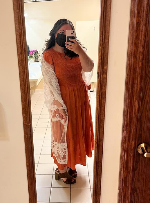 reviewer mirror selfie in the orange dress
