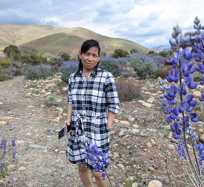reviewer image wearing the white and black plaid dress, posing on a trail