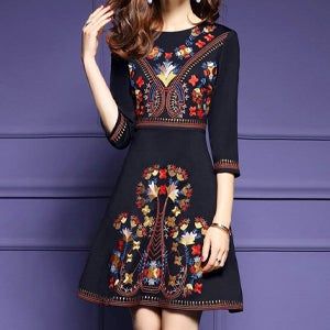 model wearing an embroidered floral dress