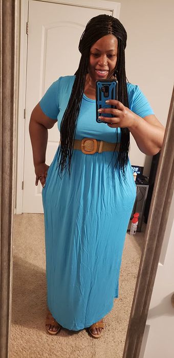 A reviewer wearing the solid turquoise version of the dress with a belt.