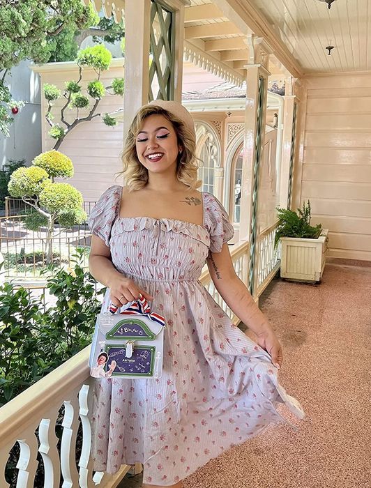 reviewer image in a lavender nap dress paired with a beret