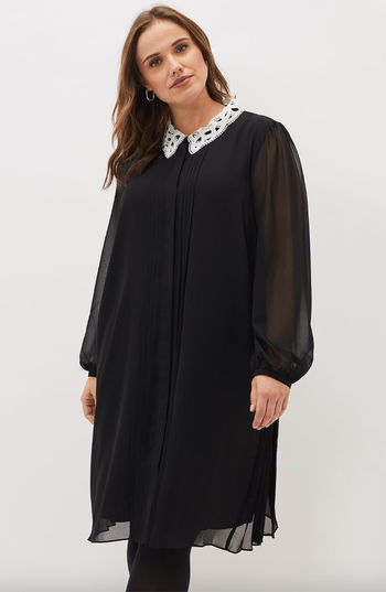 model wearing the black collared swing dress