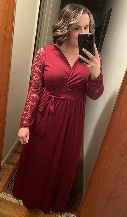 A photo of the reviewer sporting a vibrant red dress.