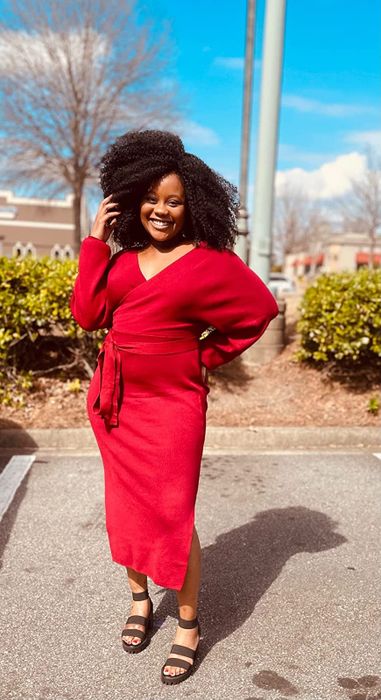 reviewer wearing the red sweater dress