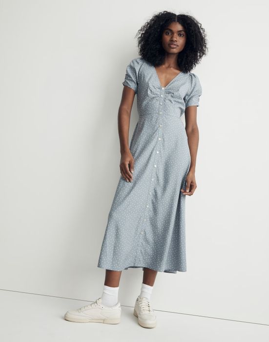Model in a blue-gray short-sleeve button-down midi dress with white polka dots