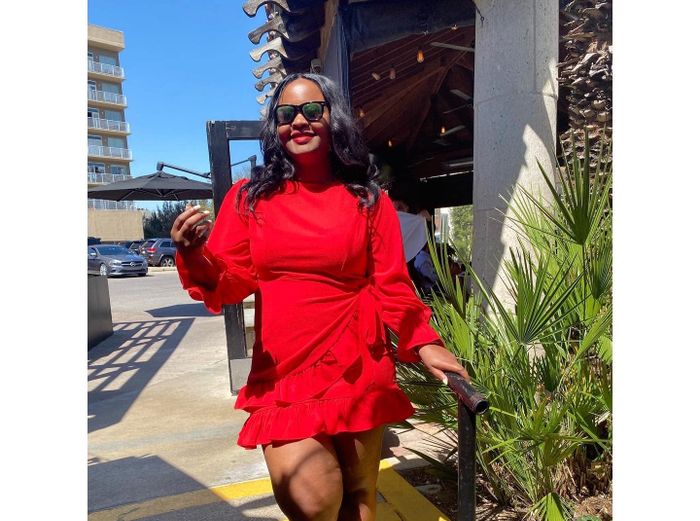 reviewer wearing the red dress