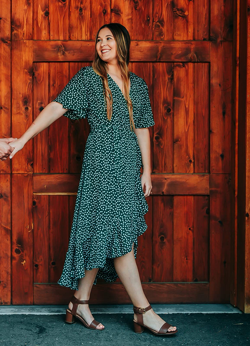 reviewer wearing the green floral dress
