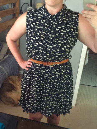 A reviewer wearing the navy and white cat print dress, which hits just above the knee.