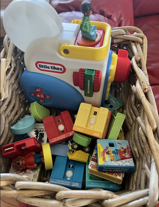 The Dream Machine projector along with its book accessories stored neatly in a basket.