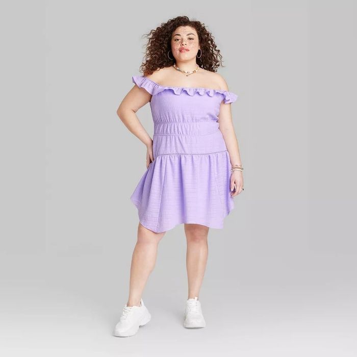 A model wearing a lilac sleeveless dress off the shoulder.