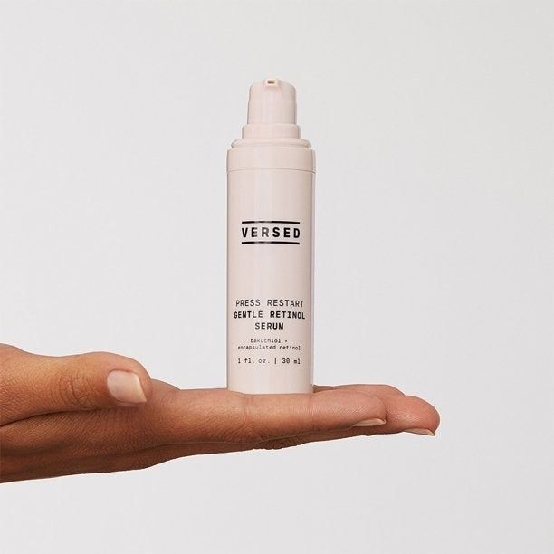 a model holding the bottle in their hand