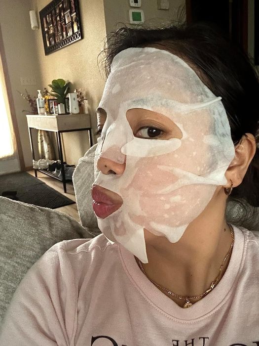 A reviewer wearing one of the Korean face masks.