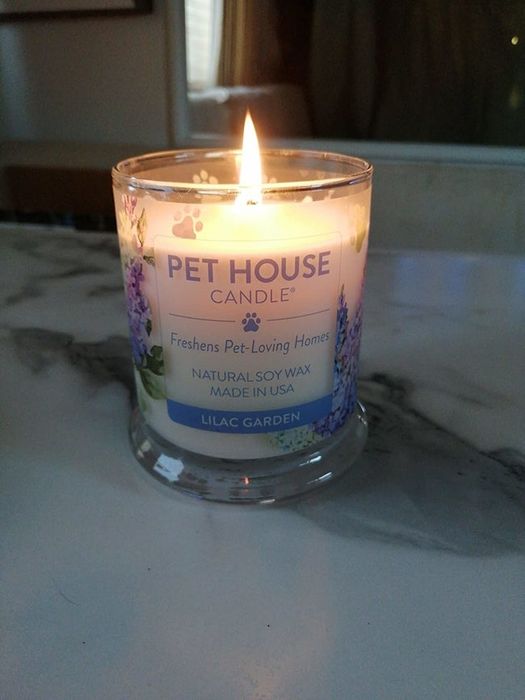 reviewer image of a lit lilac garden odor-eliminating candle
