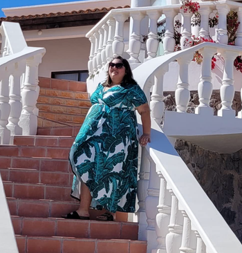 reviewer showcasing the dress in a leaf print