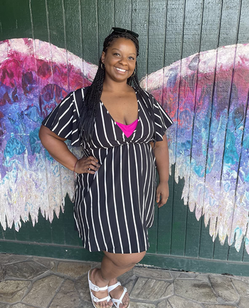 reviewer modeling the dress in black and white stripes
