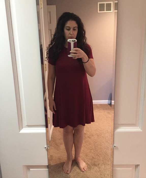 reviewer wearing the dress in red