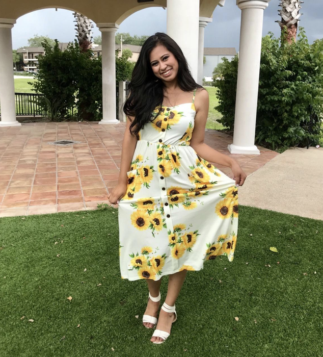 reviewer showcasing the dress in a sunflower print