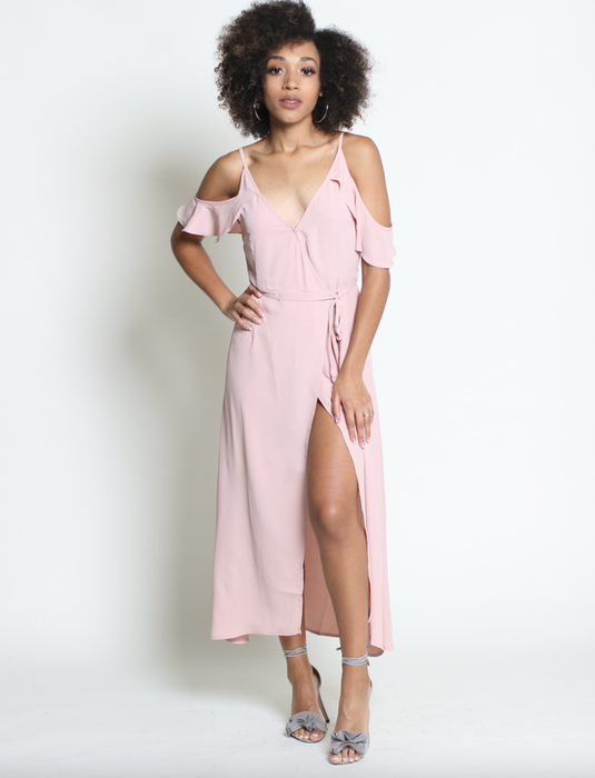 model showcasing a pink maxi wrap dress featuring cold shoulders and a leg slit