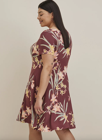 the same model displaying the back view of the dress