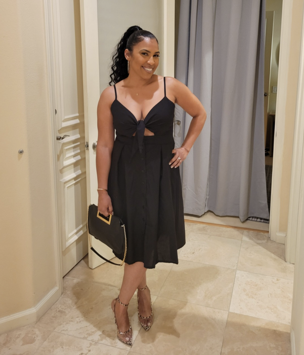 reviewer showcasing the dress in black