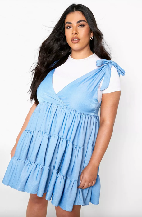 model wearing a blue dress layered over a white tee