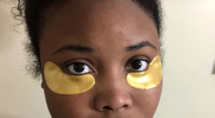A reviewer wearing the under-eye patches.