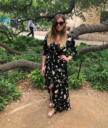 reviewer modeling the dress in black