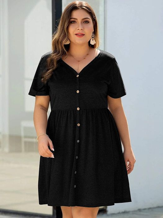 model wearing a black dress featuring button details