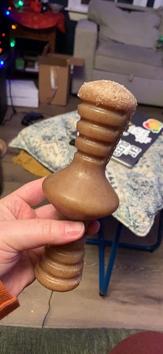 A reviewer showing off the chew toy