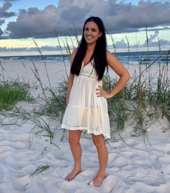 reviewer showcasing the dress in beige