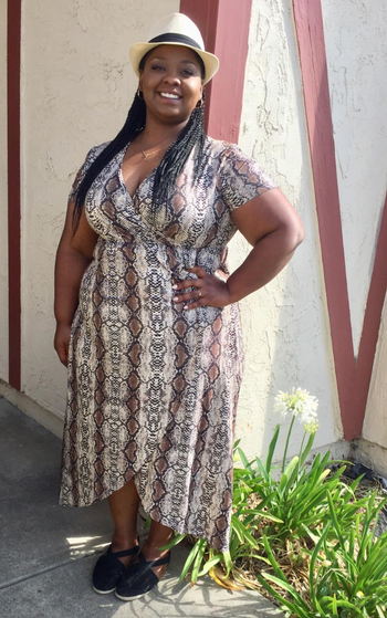 reviewer modeling the dress in a snakeskin print