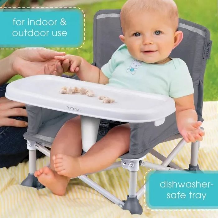 A baby sitting in a portable high chair with a tray, ideal for both indoor and outdoor use. The tray is dishwasher-safe for easy cleaning