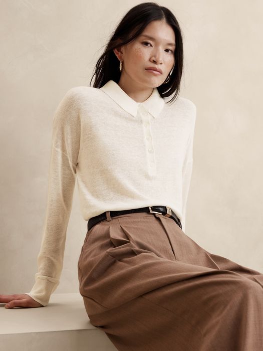 A model showcasing an off-white polo sweater paired with brown pants