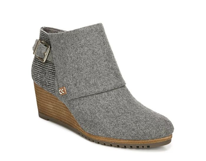 A gray ankle boot featuring a wedge heel, side buckle detail, and a textured back panel, perfect for fall or winter fashion.
