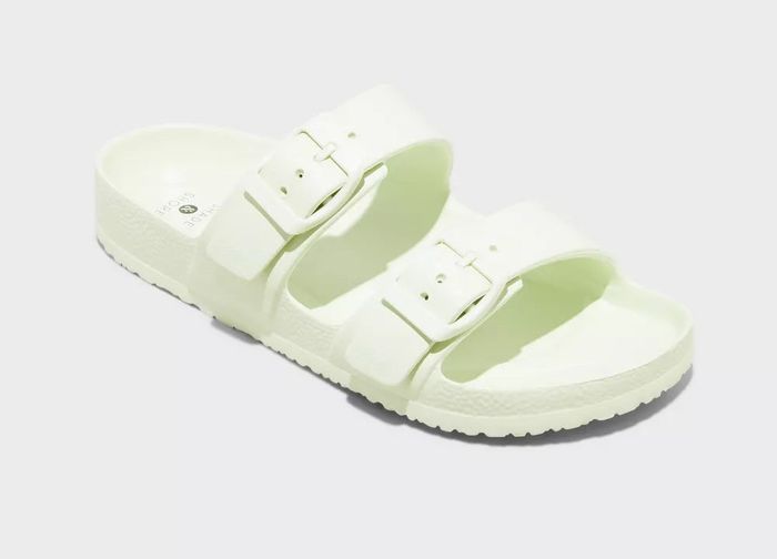 A pair of green sandals featuring buckle straps