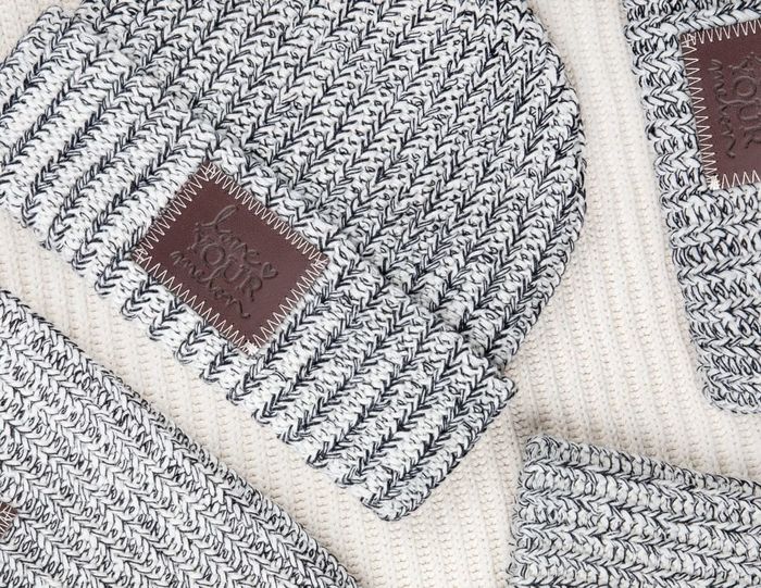 a gray and white speckled beanie