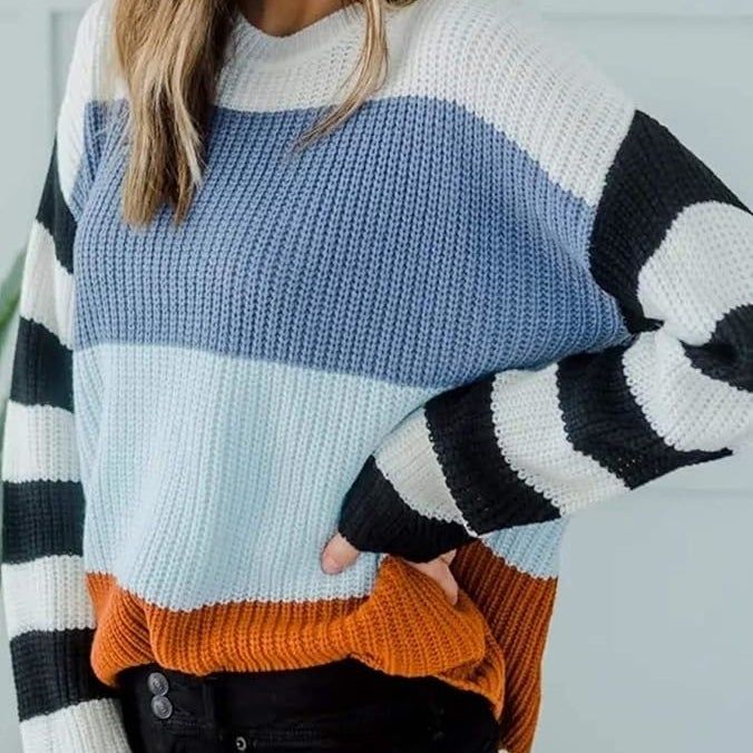 Individual donning a chic striped sweater paired with a wide-brim hat, striking a pose with hand on hip; set in a fashion-forward shopping scene