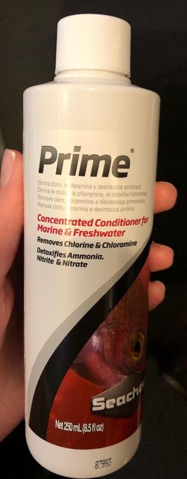 A reviewer holding the bottle of marine water conditioner