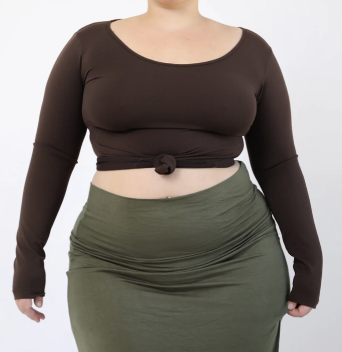 Model showcasing a fitted, brown long-sleeve cropped top with a front knot, paired with a high-waisted skirt