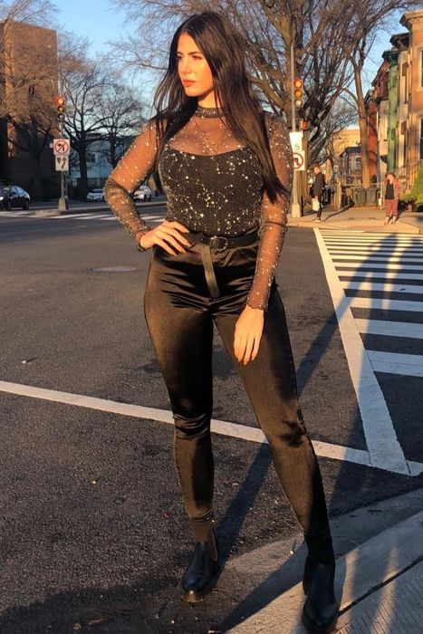 A customer review photo showcasing them wearing the top paired with black pants and a belt